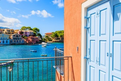 blue door of a greek house in assos bay, kefalonia island, greece