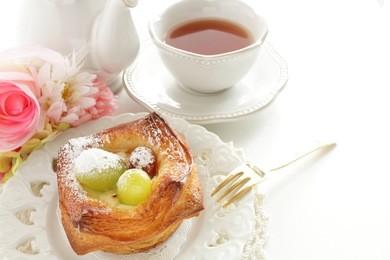 home bakery, autumn grape on danish pastry with tea on background,