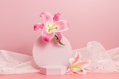 empty geometric podium with lily flowers and fabric with golden stars on pink background. gentle, cute and romantic concept. display for product presentation