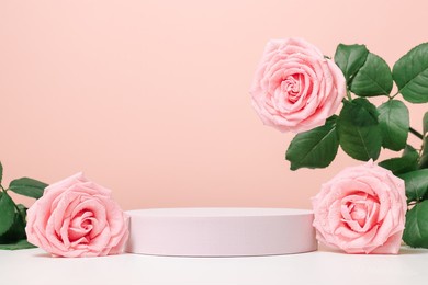 blank podium with pink roses on pink background. showcase for product, perfume, jewelry and cosmetic presentation