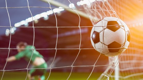 football championship: ball hits the net. goalkeeper jumps and fails to protect goals, competition scores goal. sport channel broadcast tv. stylish warm cinematic edit of international tournament.