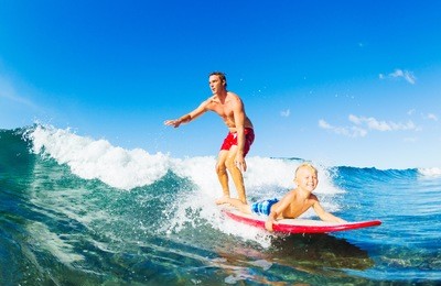 father and son surfing together