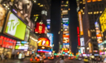 abstract view of the lights of times square in new york city at night.