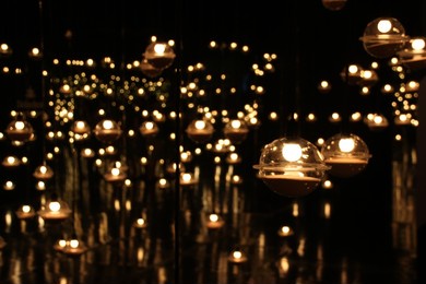 blur bokeh circus tube lamp hang from ceiling in dark room like firefly