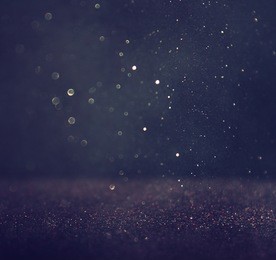 glitter vintage lights background. silver and black. defocused. 