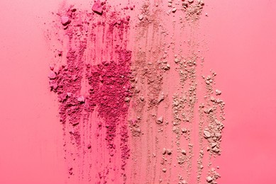 abstract composition made from crushed face powder and blush on pink background