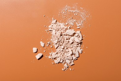 crushed face powder heap on brown background