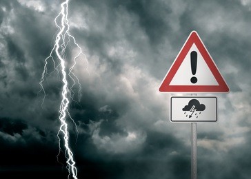 caution - thunderstorm ahead - a dark cloudy sky with a lightning bolt and a warning sign in the foreground  - computer generated image