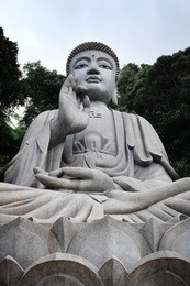 large stone buddha statue surrounded by rainforest in genting highland, malaysia