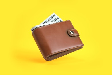 purse or wallet with money dollar bills on yellow background. 3d illustration