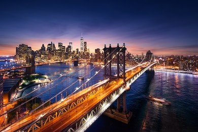 new york city - beautiful sunset over manhattan with manhattan and brooklyn bridge