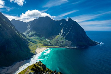 view over the turquoise water of kvalvika beach from ryten mount, lofoten islands, norway