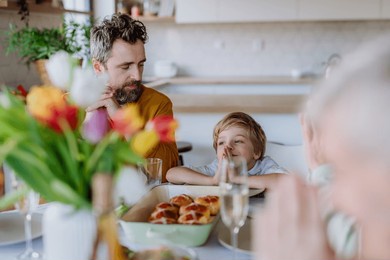 close-up of family praying before easter lunch.