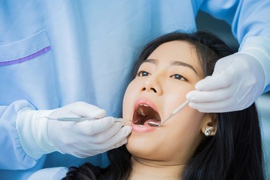 asian woman gives dentists examined the teeth
