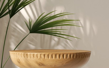 wooden round smooth grain podium table, curved, green tropical palm tree in sunlight, leaf shadow on blank beige wall for luxury organic cosmetic, skincare, beauty product background 3d