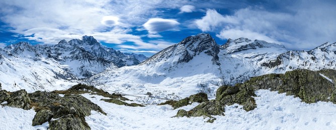 panorama of snowy mountain peaks in winter. winter mountain panorama in snow. snowy mountain panoramic landscape. winter snow mountains