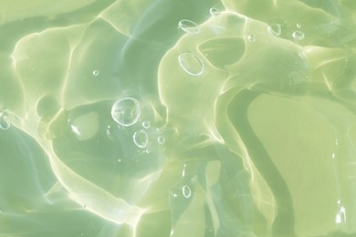 the texture of a green gel or serum with hyaluronic acid for the face. cosmetic transparent liquid cream with oxygen bubbles. wellness and beauty concept. sanitizer, virus protection. soft focus.