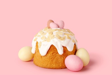easter cake with painted eggs on pink background