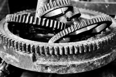 the sprocket gear to old rusty, black and white photo.