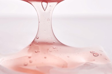 the texture of a pink viscous cosmetic product.