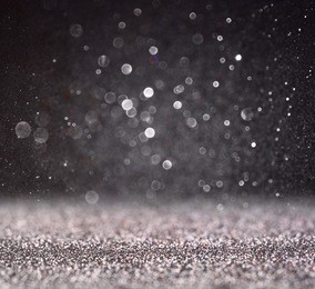 glitter vintage lights background. silver and black. defocused. 