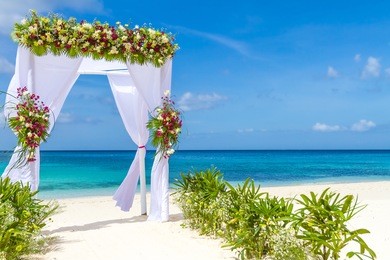 wedding arch and set up on beach, tropical outdoor wedding cabana on beach