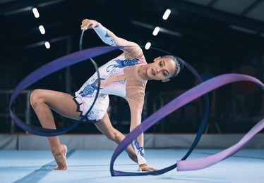 ribbon, gymnastics and woman dancer in performance, action and sports competition. female, rhythmic movement and flexible dancing athlete, creative skill and talent of concert event in practice arena