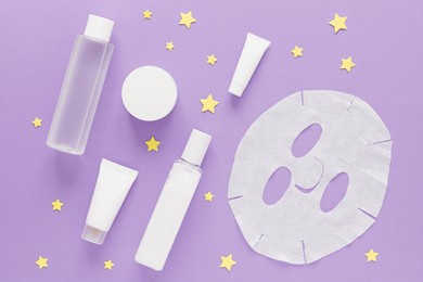 a set of face care cosmetics and stars on a purple background. evening skin care before bed. beauty. self care. moisturizing the skin of the face. cream, face mask, toner.