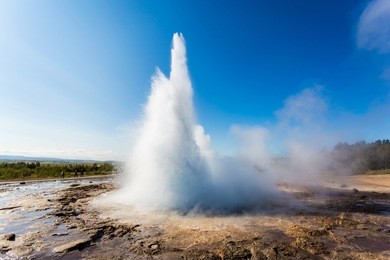 stokkur geyser erupting in iceland, geysir. blue sky, sunny day.