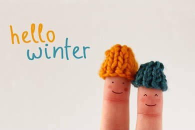 hello winter - smiling finger people couple with red cheeks wearing knitted woolen hats