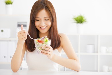 beautiful asian young woman eating healthy food