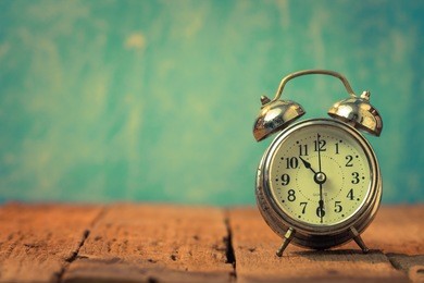 vintage background with retro alarm clock on table