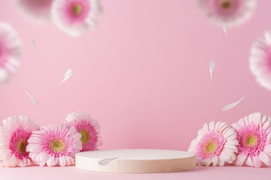 wooden round podium pedestal cosmetic beauty product presentation empty mockup on  pink background with gerbera flowers