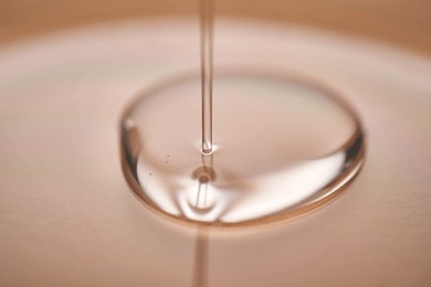 a juicy drop of gel on a beige background.