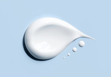 cosmetic smears of creamy texture on a blue background