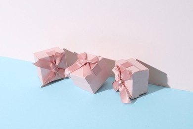 conceptual holiday photo. pink gift boxes on pastel background with shadow