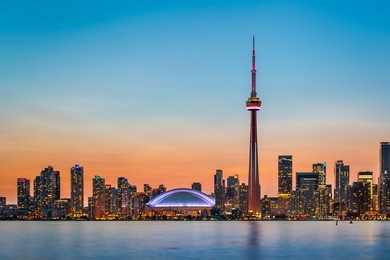 skyline of toronto over ontario lake at twilight