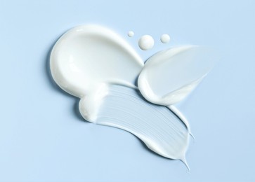cosmetic smears of creamy texture on a blue background