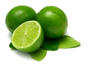 two whole limes, one half lime, with leaves, isolated on white