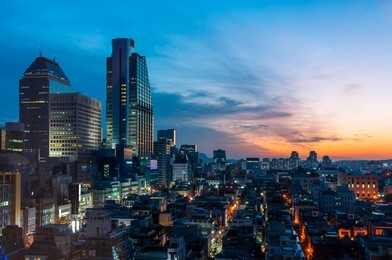 the sun sets over the gangnam district of seoul, south korea.