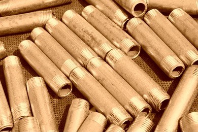 short metal pipes with external thread, closeup of photo