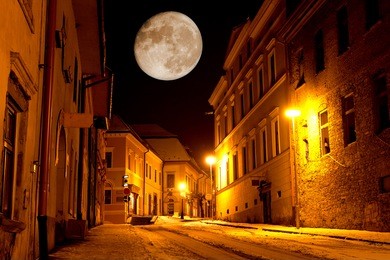 night scene with big moon in old city