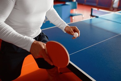 closeup view on male athlete hands holding racket to play ping pong