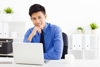 smiling young business man working in the  office