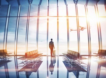 businessman at airport with suitcase