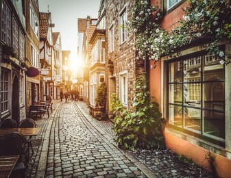 old town in europe at sunset with retro vintage instagram style filter and lens flare effect