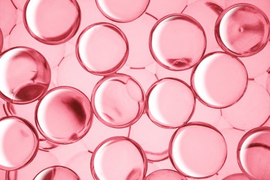 cream gel drops red transparent cosmetic sample texture with bubbles on pink background
