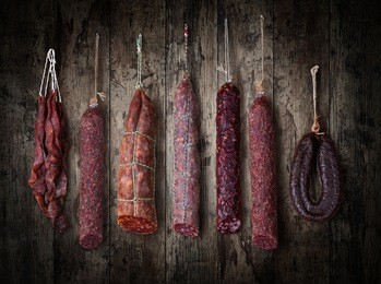 salami sausages on a wooden background
