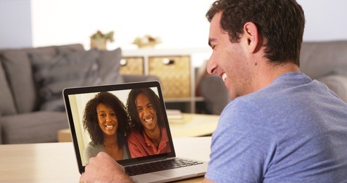 diverse friends videochatting on laptop