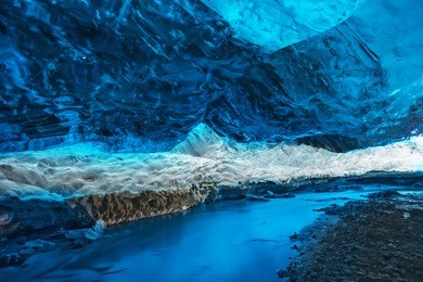 awesome big ice cave and river at vatnajokull glacier, iceland